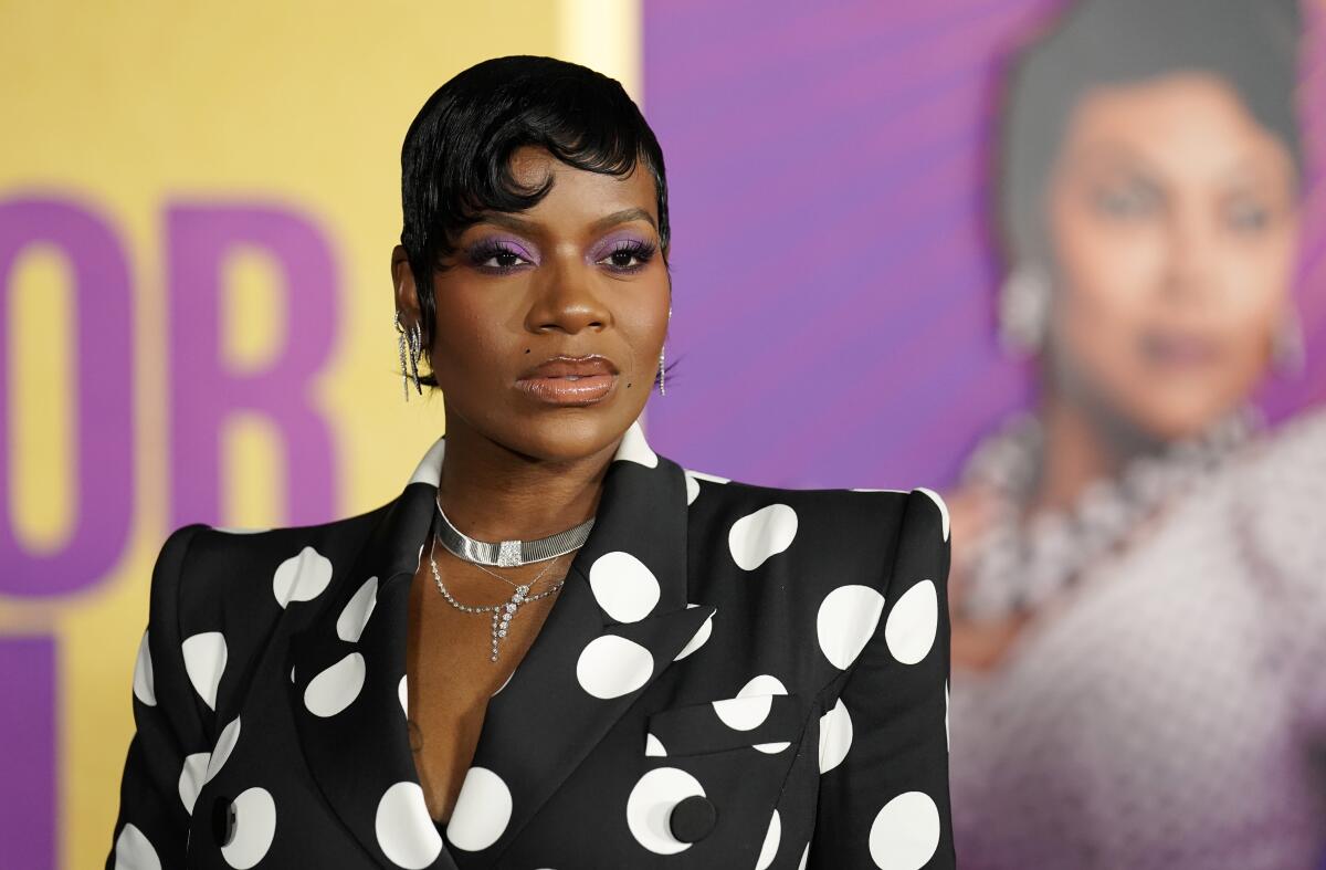 Fantasia Barrino with short black hair poses while wearing a black-and-white polka dot dress and silver jewelry