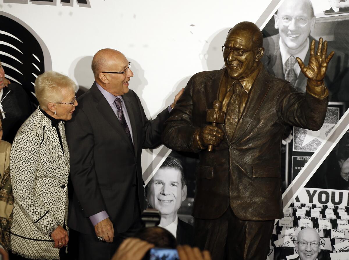 A statue honoring Kings broadcasting legend Bob Miller, with his wife Judy, is unveiled Jan. 13, 2018.