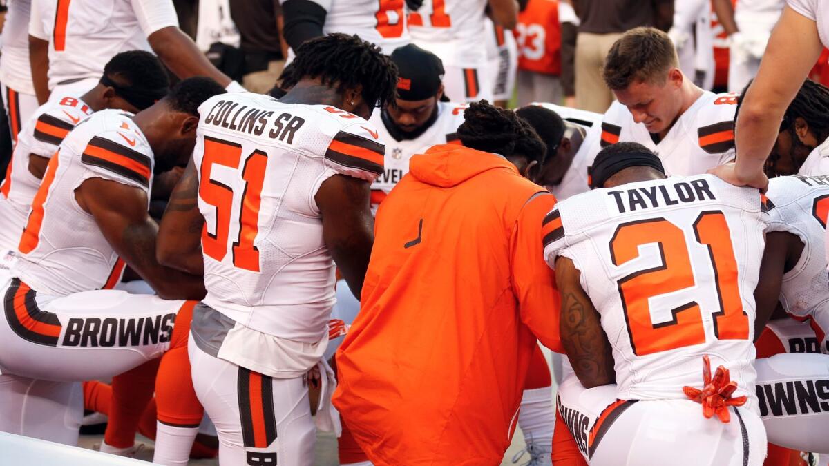 Members of the Cleveland Browns kneel in prayer during the national anthem before an exhibition game against the New York Giants on Monday.