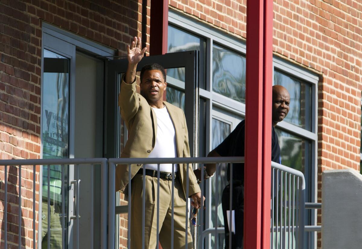 Former U.S. Rep. Jesse Jackson Jr. waves as he leaves a halfway house Monday in Baltimore.