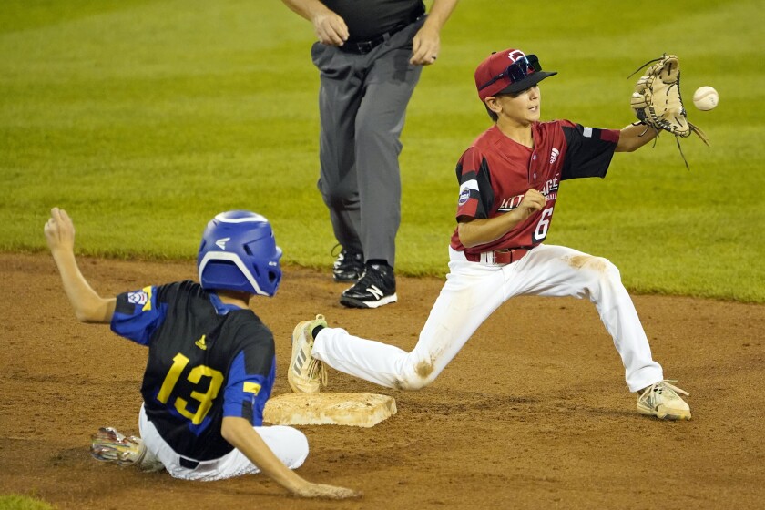 Hamilton, Ohio shortstop Cooper Clay stretches for the ball to force out Torrance Little League's Brandon Perez.