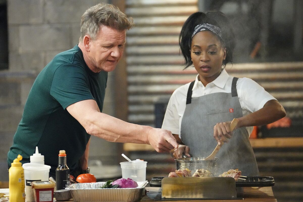 Chef Gordan Ramsay and contestant Mariah Scott cook at a stove in "Next Level Chef" on Fox.