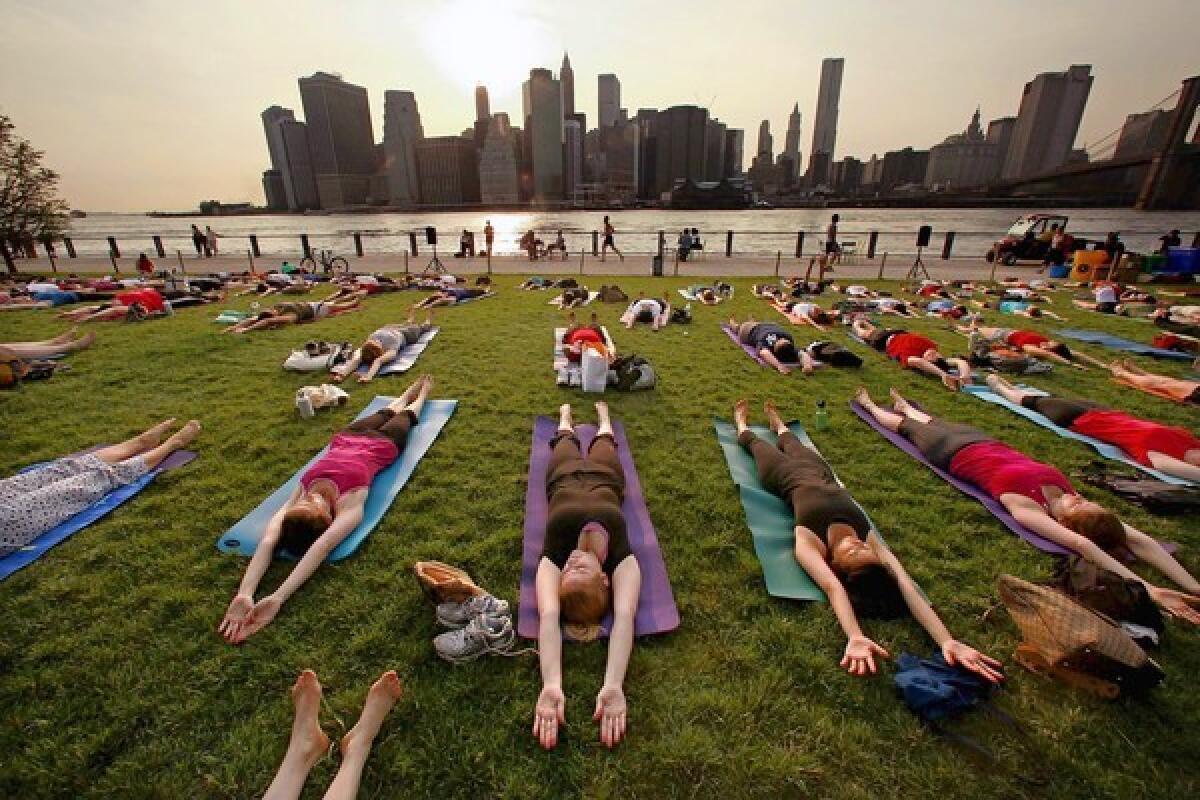 Touring the sights of New York can include fitness classes, such as this one in Brooklyn Bridge Park, across from lower Manhattan.