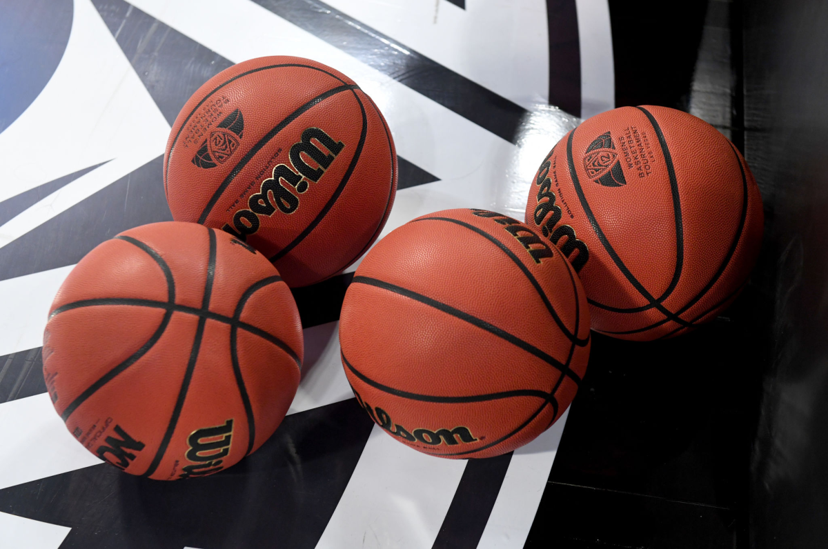 Basketballs are shown on the floor during warmups before a game.