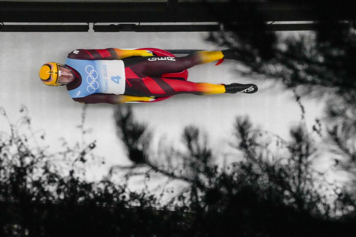 Johannes Ludwig of Germany slides through a curve during a luge run Sunday.