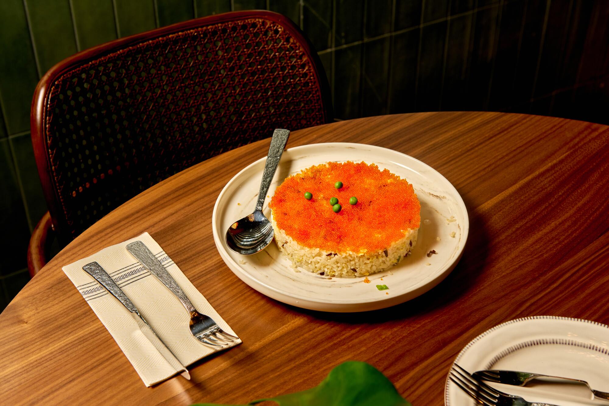 Corona Real fried rice with black and white jasmine rice in a circular mold covered with fish eggs.