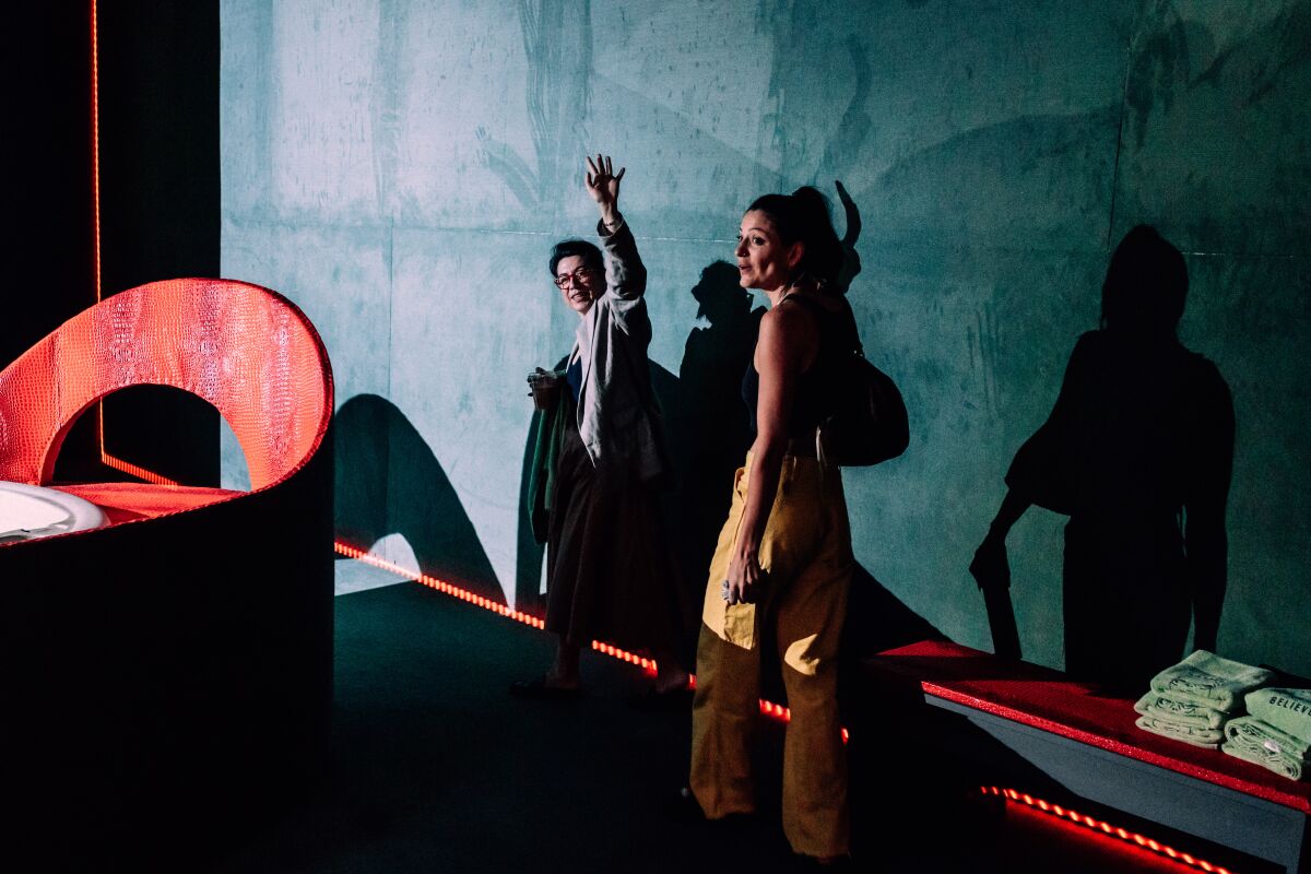 Two women at an art exhibit.