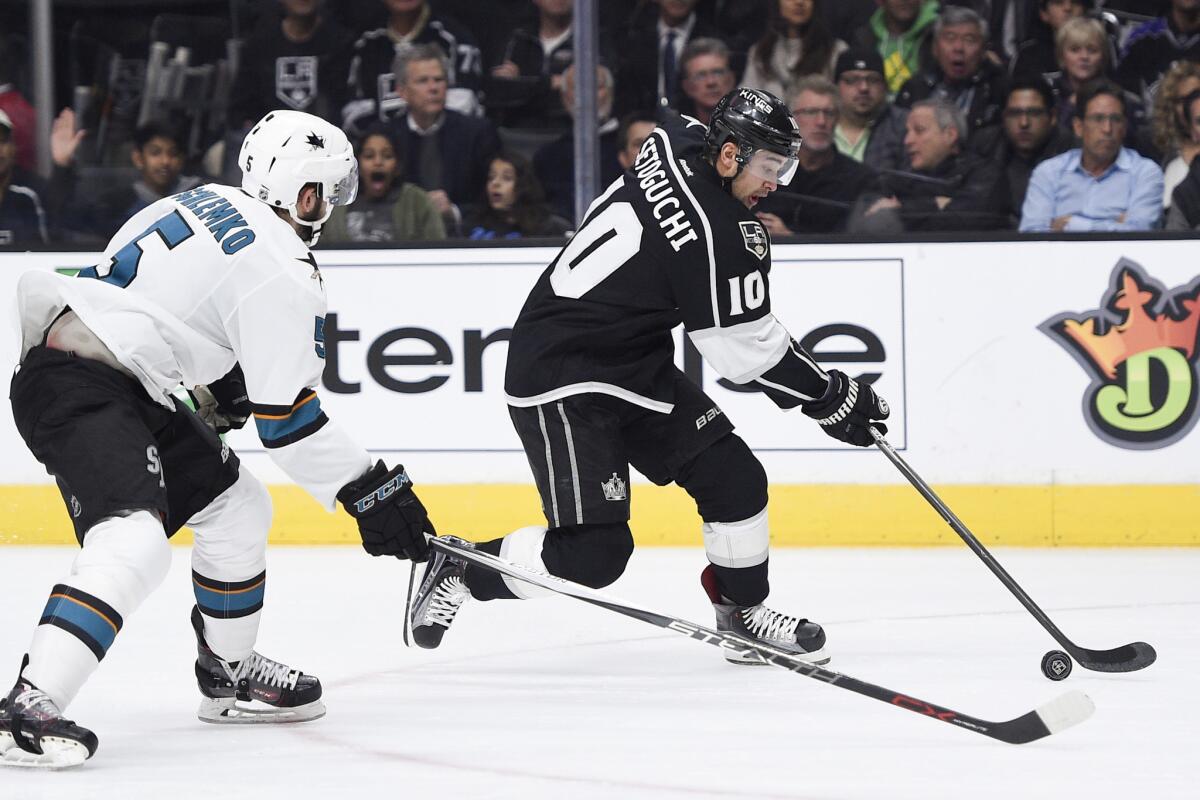 Kings right wing Devin Setoguchi (10) handles the puck while being defended by San Jose Sharks defenseman David Schlemko (5) during the second period on Nov. 30.