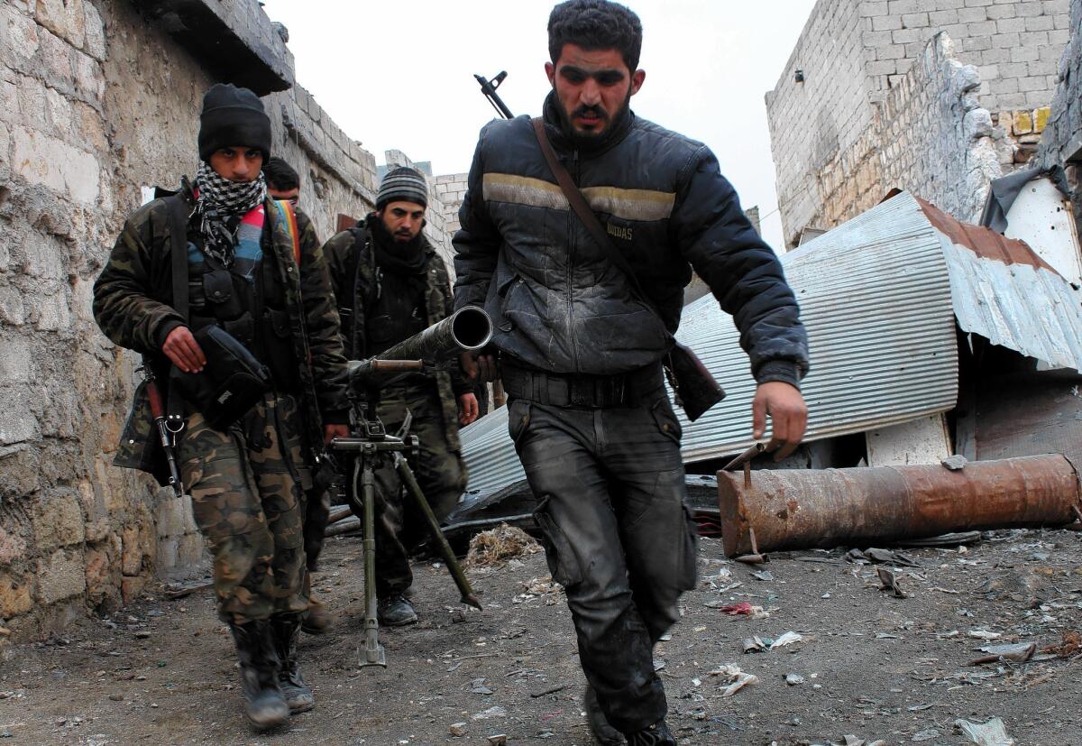 Opposition fighters carry a rocket launcher during clashes against Syrian government forces in Aleppo. A deal brokered at peace talks in Geneva to get humanitarian aid to residents trapped in the rebel-held Old City of Homs is in danger of unraveling.