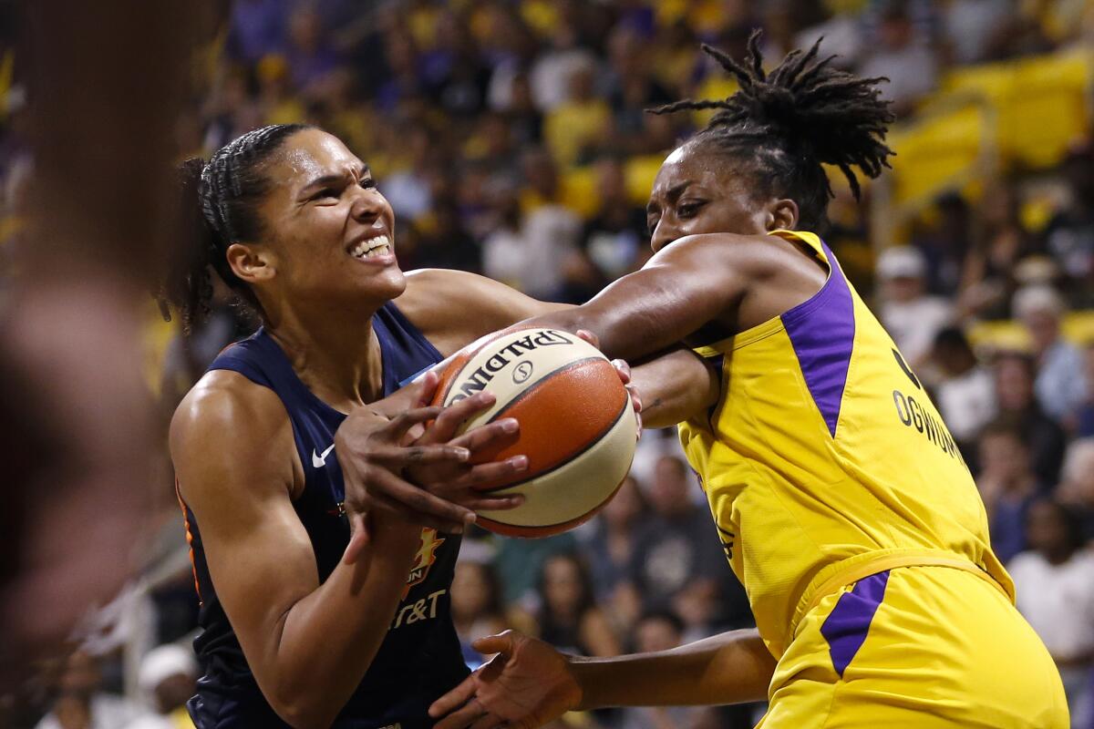 Sparks forward Nneka Ogwumike fouls Sun forward Alyssa Thomas during Game 3 on Sunday.