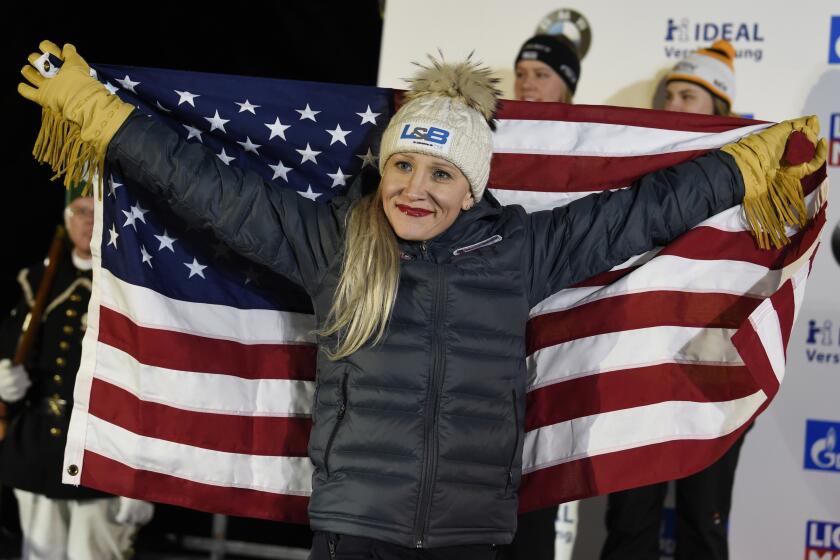 FILE - Gold medalist Kaillie Humphries of the United States celebrates during the medal ceremony for the two-woman bobsled competition at the Bobsleigh and Skeleton World Championships in Altenberg, Germany, in this Saturday, Feb. 22, 2020, file photo. Humphries will seek a record fourth women’s bobsled world championship this weekend in Altenberg. (AP Photo/Jens Meyer, File)
