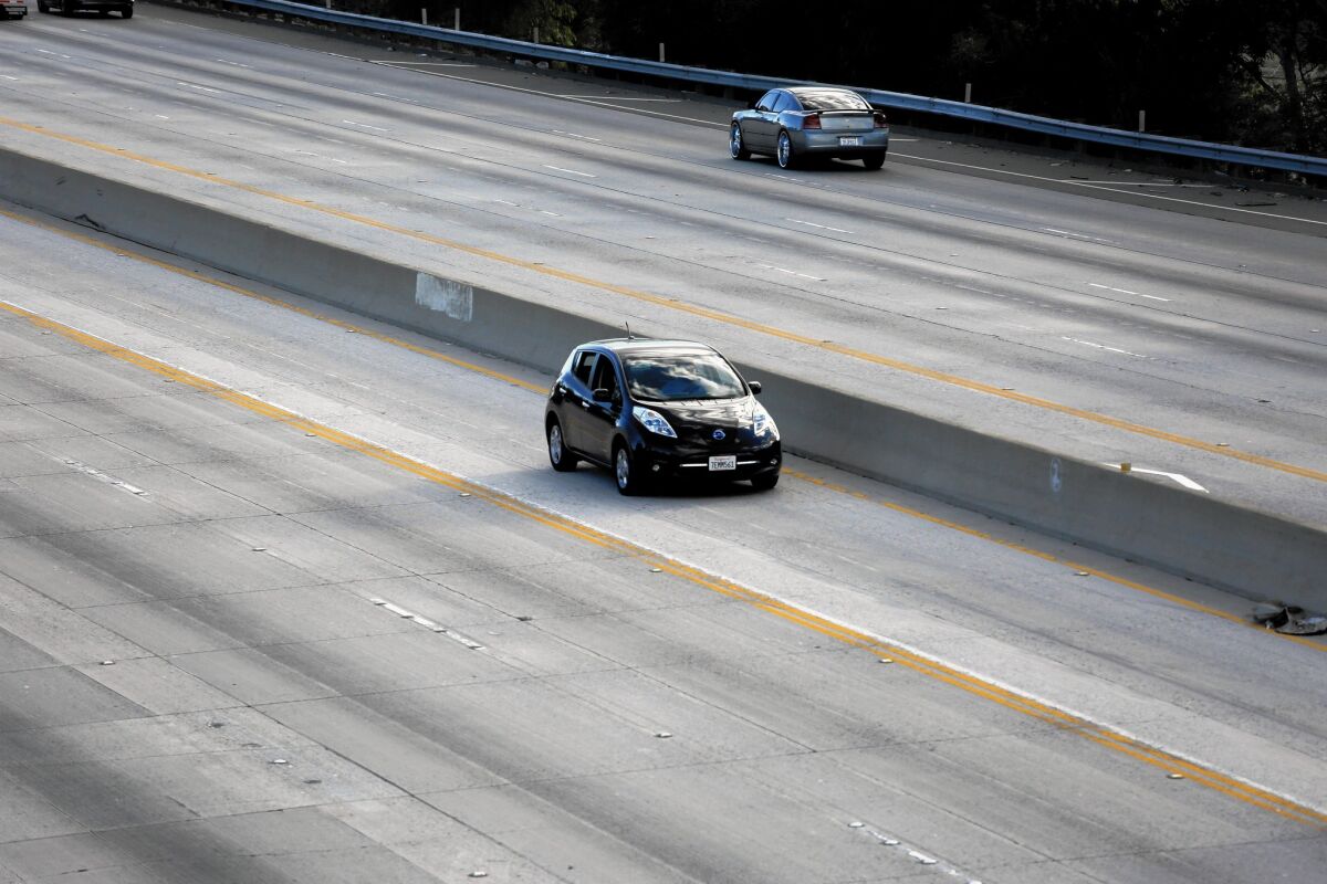 A Nissan Leaf travels down a carpool lane on the northbound 170 Freeway.