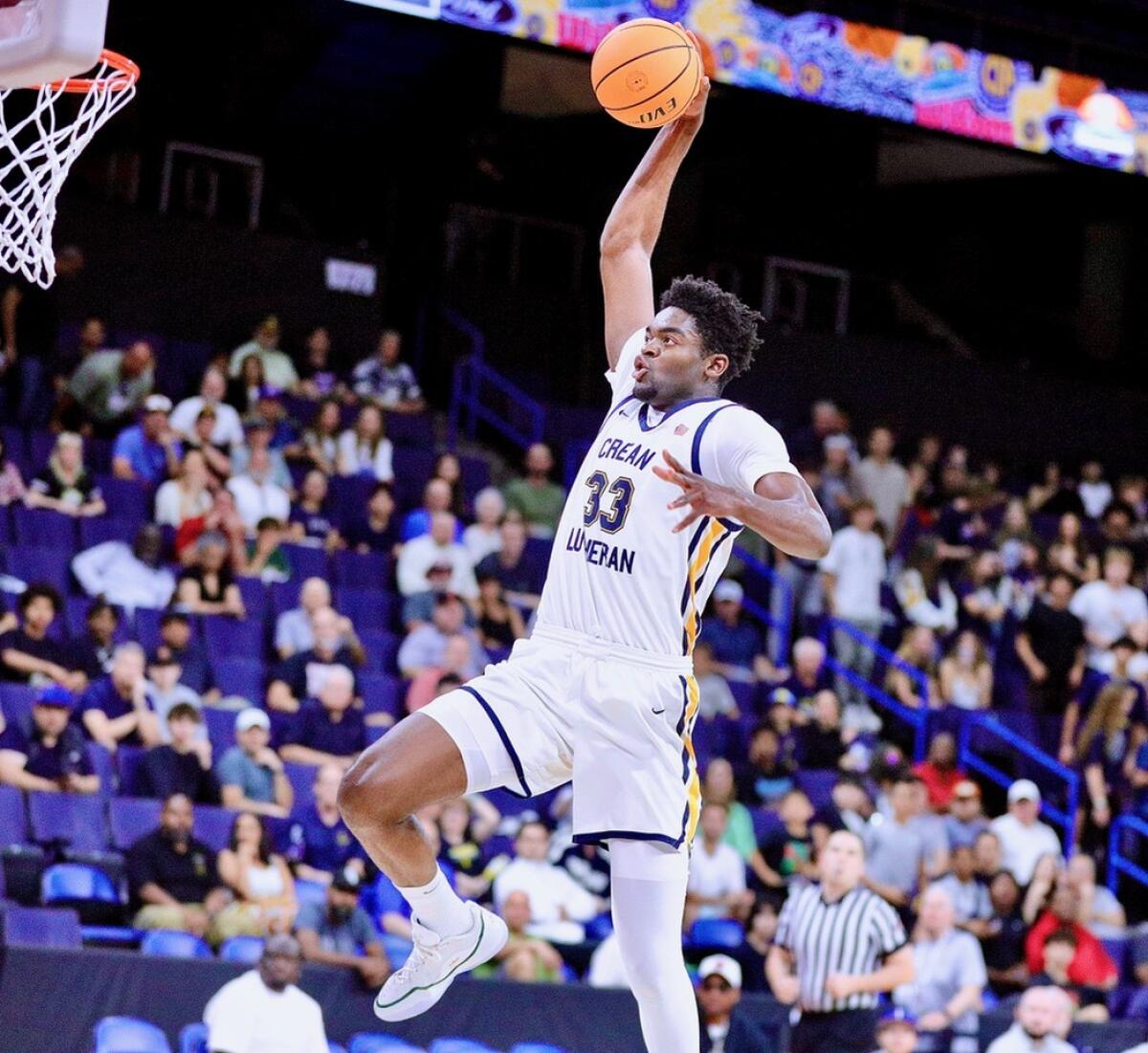 Crean Lutheran's Chadrack Mpoyi dunks against JSerra.
