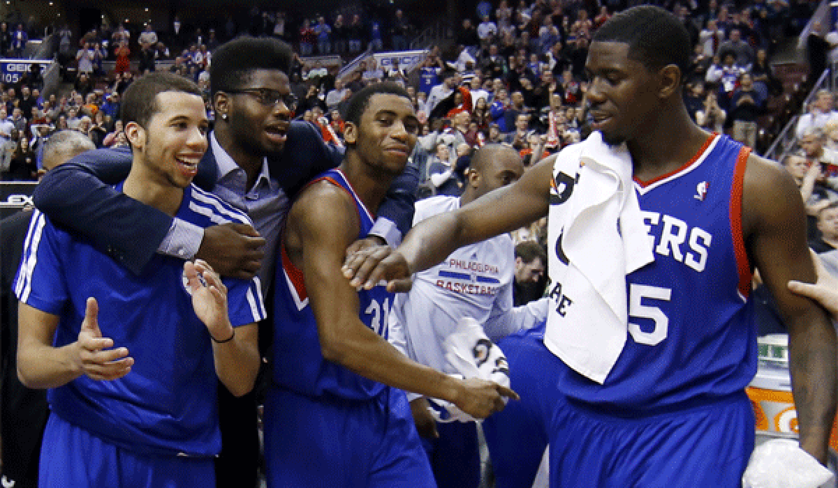 Philadelphia's Michael Carter-Williams, left, Nerlens Noel, Hollis Thompson and Henry Sims celebrate the 76ers' first win in two months, 123-98 over Detroit on Saturday night.