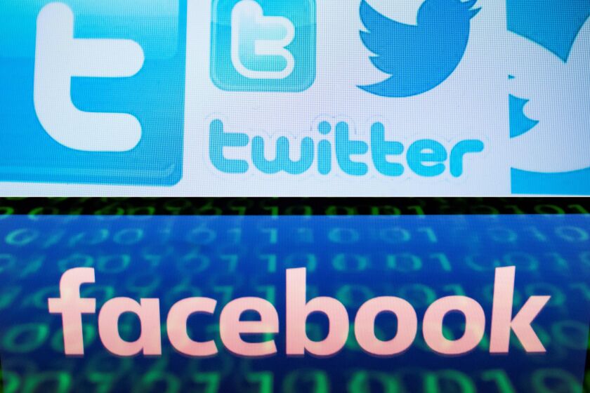 (COMBO) This combination of file pictures created on August 22, 2018 shows a photo illustration taken on March 23, 2018 of Twitter logos on a computer screen in Beijing and a file illustration picture taken on April 28, 2018 of the logo of social network Facebook displayed on a screen and reflected on a tablet in Paris. - A concerted Russian hacking and online disinformation campaign in 2016 sought to tip the US presidential election toward Donald Trump. Two weeks ahead of midterm congressional elections, Moscow's operatives are at it again. The shutdown of thousands of Russian-controlled accounts by Twitter and Facebook -- plus the indictments of 14 people from Russia's notorious troll farm the Internet Research Agency -- have blunted but by no means halted their efforts to influence US politics. (Photos by NICOLAS ASFOURI and Lionel BONAVENTURE / AFP) (Photo credit should read NICOLAS ASFOURI,LIONEL BONAVENTURE/AFP/Getty Images)