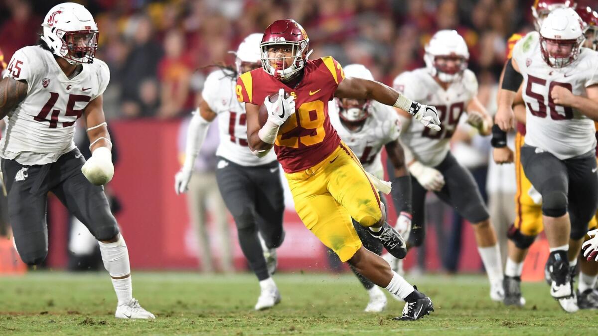 USC running back Vavae Malepeai picks up big yards against Washington State in the fourth quarter at the Coliseum on Friday.