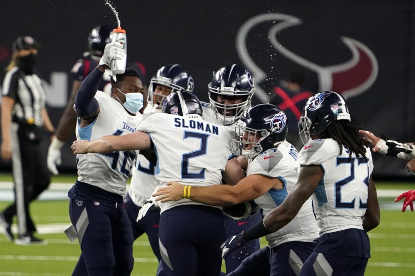 Tennessee Titans kicker Sam Sloman (2) celebrates with teammates after kicking the game-winning field goal against the Houston Texans during the second half of an NFL football game Sunday, Jan. 3, 2021, in Houston. The Titans won 41-38. (AP Photo/Sam Craft)