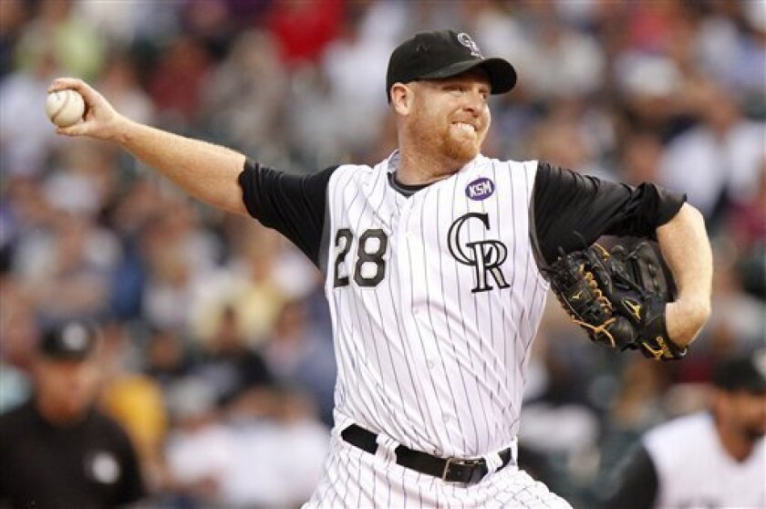 Colorado Rockies starting pitcher Aaron Cook pitches against the Cincinnati Reds during the first inning of a baseball game at Coors Field in Denver on Wednesday, Sept. 8, 2010. (AP Photo/Barry Gutierrez)