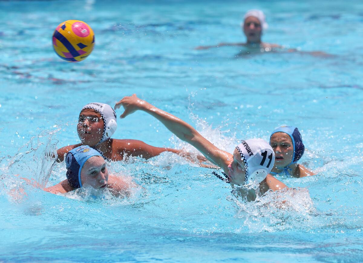 Tanner Thomas (11) of the Newport Beach 12-and-under water polo team throws in a goal on Tuesday.