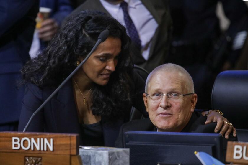 Los Angeles, CA - October 11: Council member Nithya Raman shows her support to Councilman Mike Bonin at city council meeting. City Hall on Tuesday, Oct. 11, 2022 in Los Angeles, CA. (Irfan Khan / Los Angeles Times)