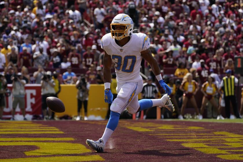 Los Angeles Chargers running back Austin Ekeler (30) runs into the end zone for a touchdown against the Washington Football Team during the first half of an NFL football game, Sunday, Sept. 12, 2021, in Landover, Md. (AP Photo/Alex Brandon)