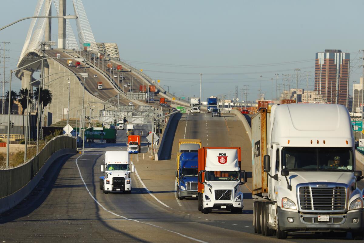 Trucks coming off a bridge