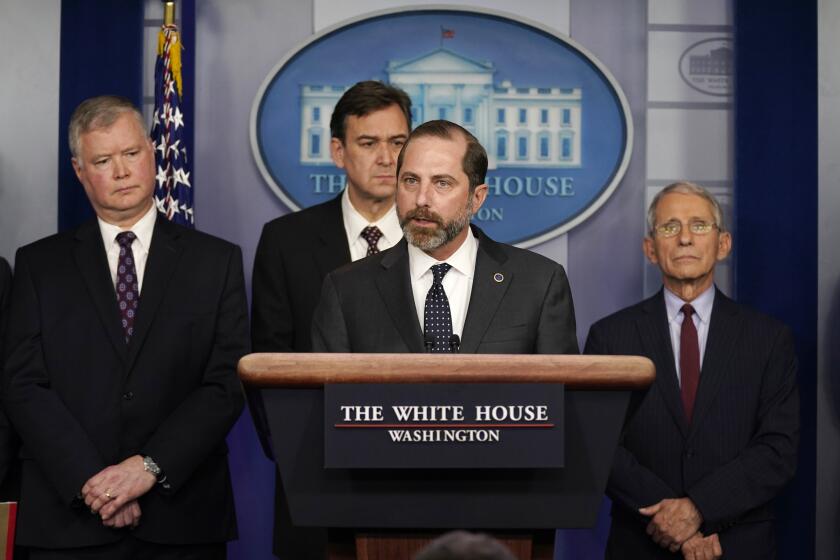 Health and Human Services Secretary Alex Azar speaks about the coronavirus in the briefing room of the White House, Friday, Jan. 31, 2020, in Washington. From left are Department of Transportation, Deputy Secretary of State Stephen Biegun, Joel Szabat, Acting Under Secretary for Policy, Azar, and National Institute of Allergy and Infectious Diseases Director Anthony Fauci.(AP Photo/ Evan Vucci)