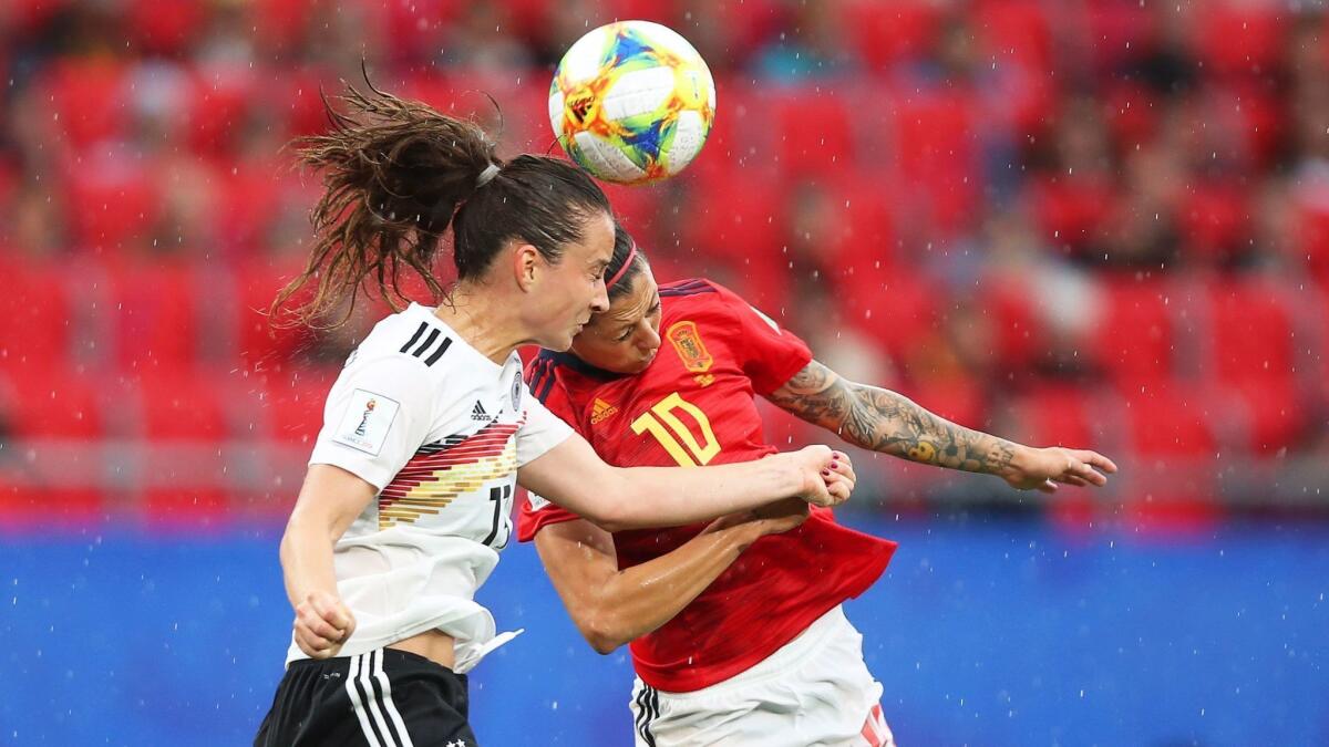 Germany's Sara Daebritz, left, vies for the ball with Spain's Jennifer Hermoso during a Women's World Cup Group B game Wednesday in Valenciennes, France.