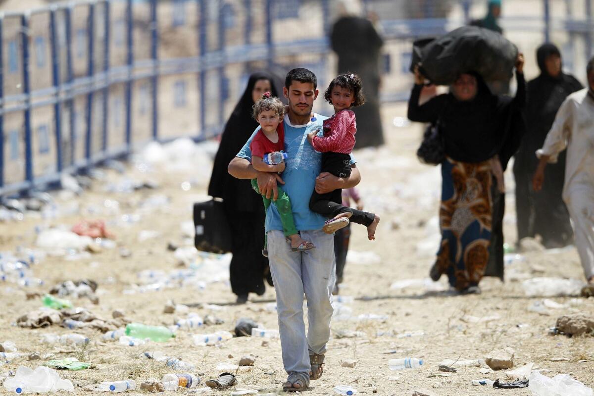 Syrian refugees cross into Akcakale, Turkey.