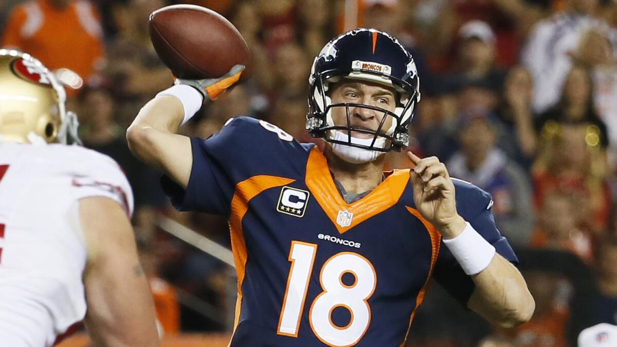 Denver Broncos quarterback Peyton Manning passes during the first half of Sunday's game against the San Francisco 49ers.