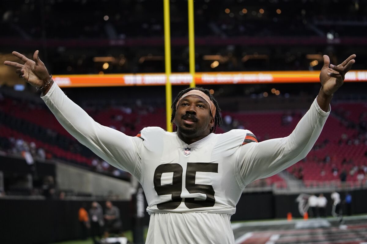 Cleveland Browns defensive end Myles Garrett (95) speaks to fans before the first half of a preseason NFL football game between the Atlanta Falcons and the Cleveland Browns, Sunday, Aug. 29, 2021, in Atlanta. (AP Photo/Brynn Anderson)