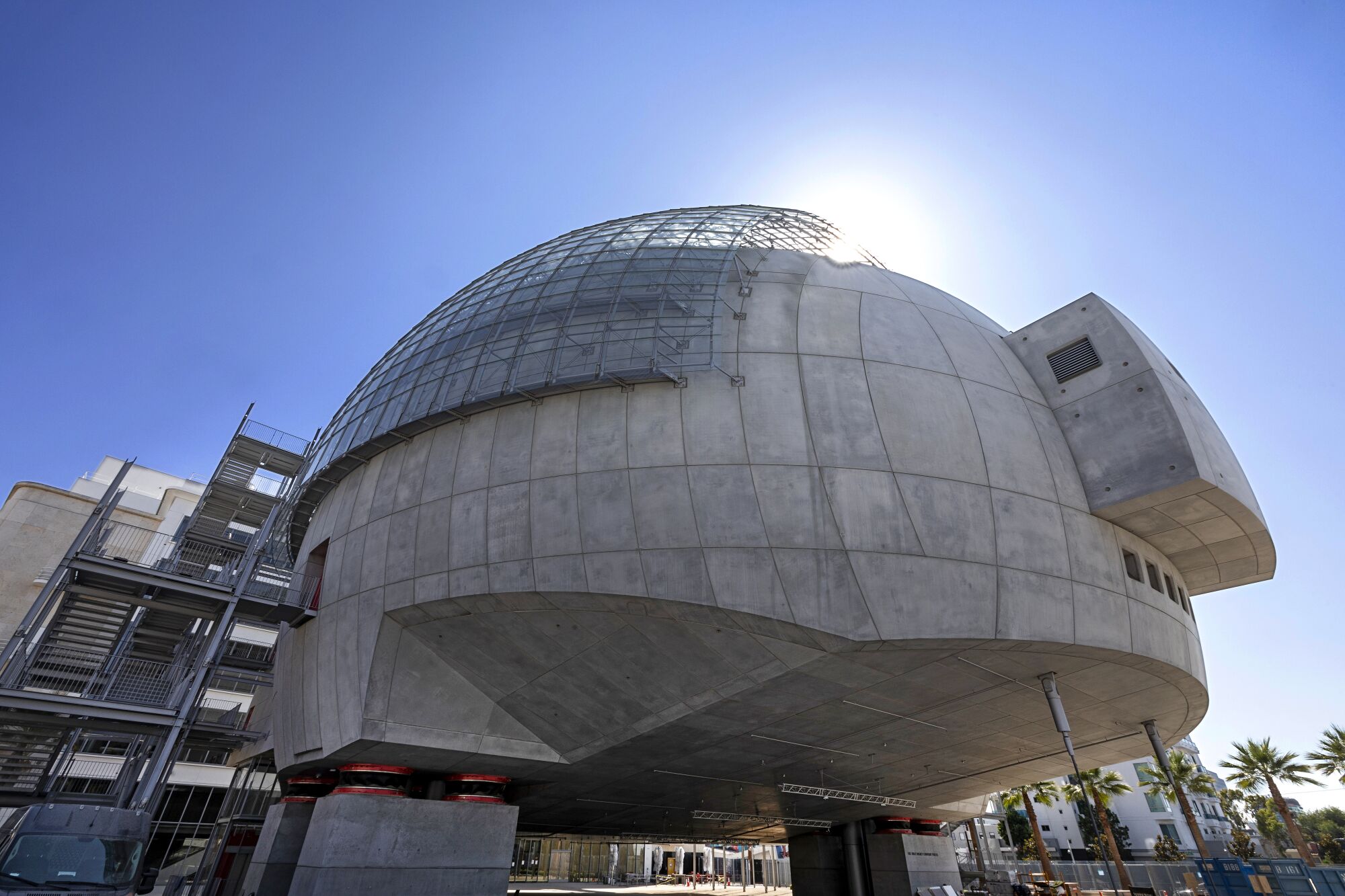 The Academy Museum's spherical David Geffen Theater hovers over a public plaza. 