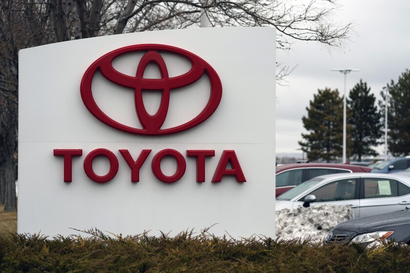 FILE - In this Sunday, March 21, 2021 file photo, The company logo adorns a sign outside a Toyota dealership in Lakewood, Colo. Toyota has reversed itself and says its political action committee will no longer contribute to legislators who voted against certifying Joe Biden’s presidential election win. The move comes after a social media backlash over the contributions, with threats to stop buying Toyota vehicles. (AP Photo/David Zalubowski, File)