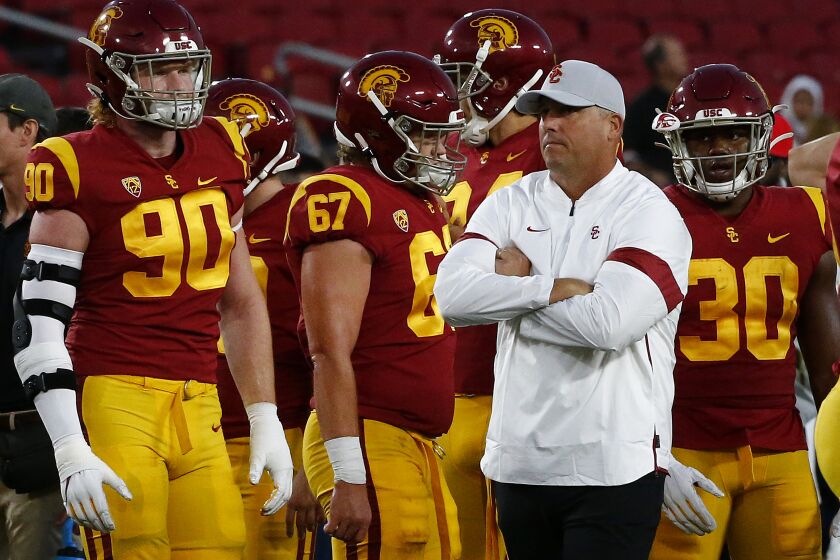 LOS ANGELES, CALIF. - OCT. 19, 2019. IUSC head coach Clay Helton watches his team warm up before the game against Arizona at the Coliseum on Saturday night, Oct. 19, 2019. (Luis Sinco/Los Angeles Times)