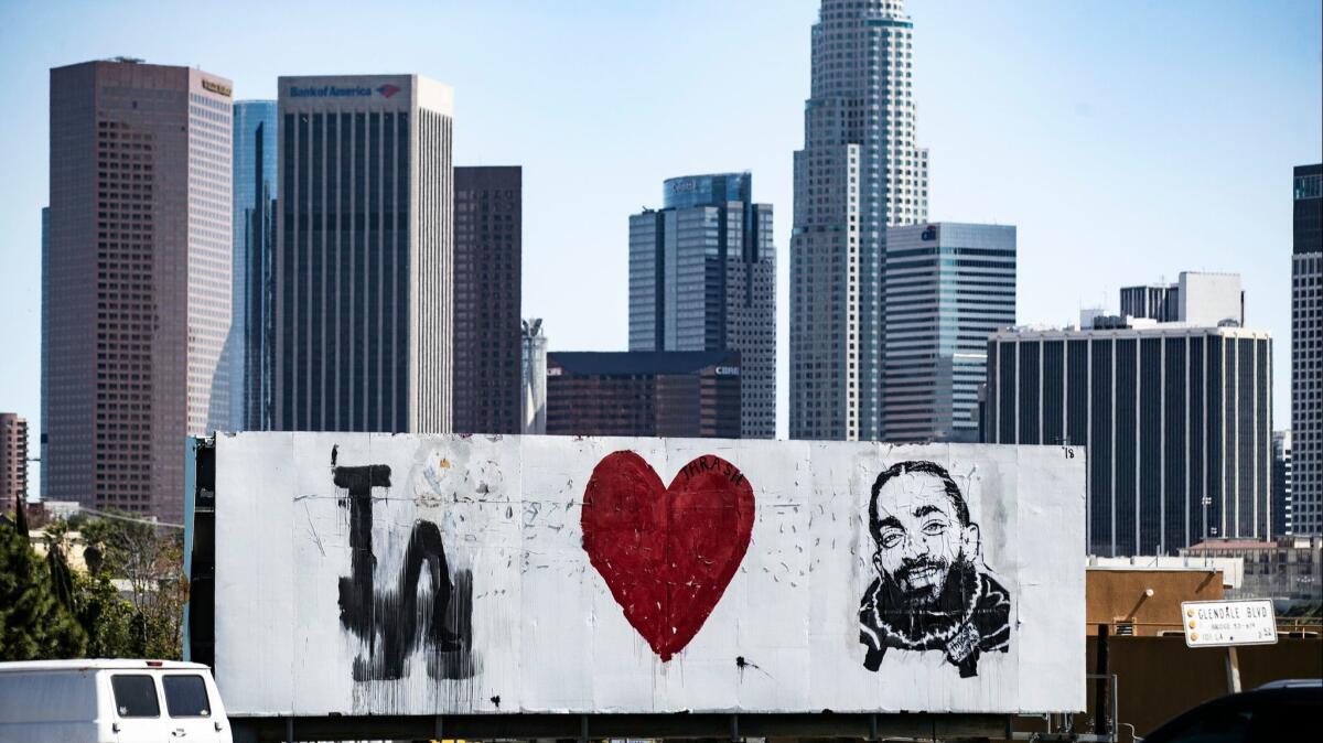 A billboard proclaiming L.A. loves Nipsey Hussle overlooks a freeway on April 12.