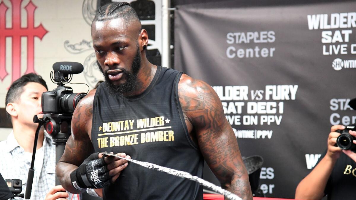 Deontay Wilder removes his hand wraps after a media day workout Nov. 5 in Santa Monica.