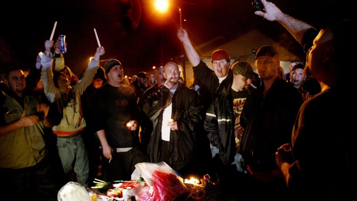 Fans of "Dimebag" Darrell Abbott sing during a candlelight vigil outside the Alrosa Villa club in Columbus, Ohio, on Dec. 9, 2004.