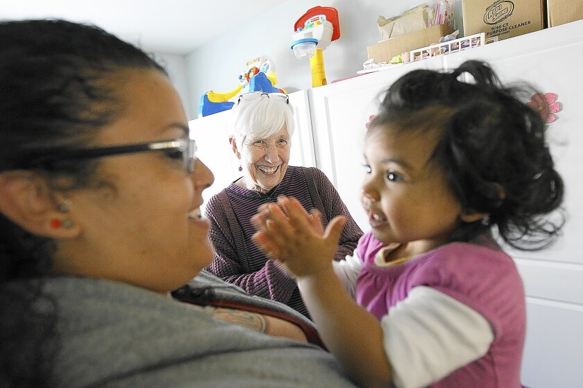 Sister Judy Vaughan, center, visits with Alexandria House resident Jennifer Garcia and her daughter, Harley Varela. Sister Judy founded the Alexandria House, a transitional shelter for homeless women and children, 18 years ago, relying on donations by primarily Catholic groups to keep it running.