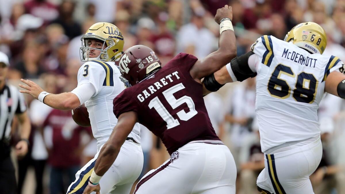UCLA quarterback Josh Rosen is pressured by Texas A&M's Myles Garrett during a game at Kyle Field in College Station, Texas, on Sept. 3, 2016.