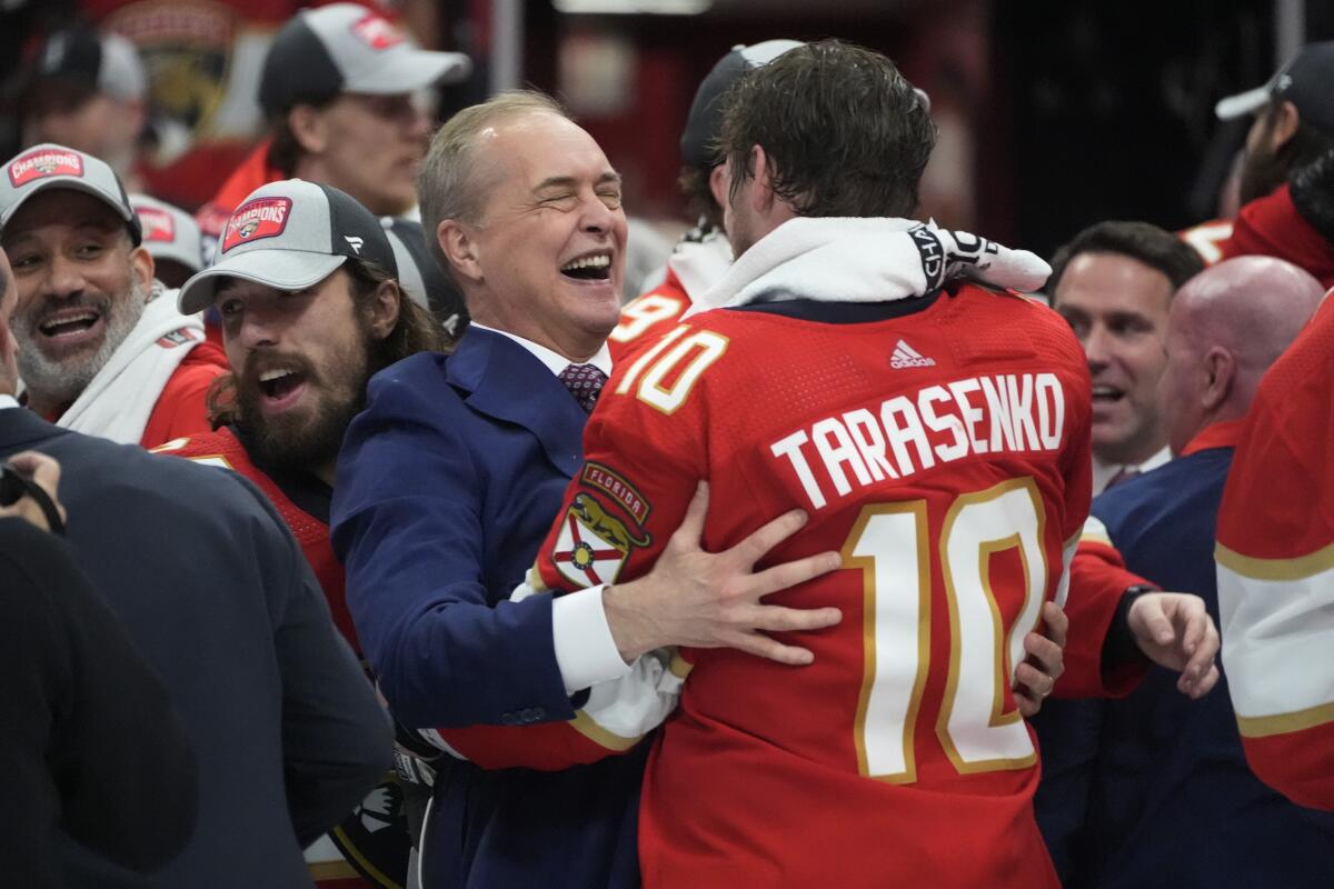 Florida Panthers coach Paul Maurice, left, hugs forward Vladimir Tarasenko.