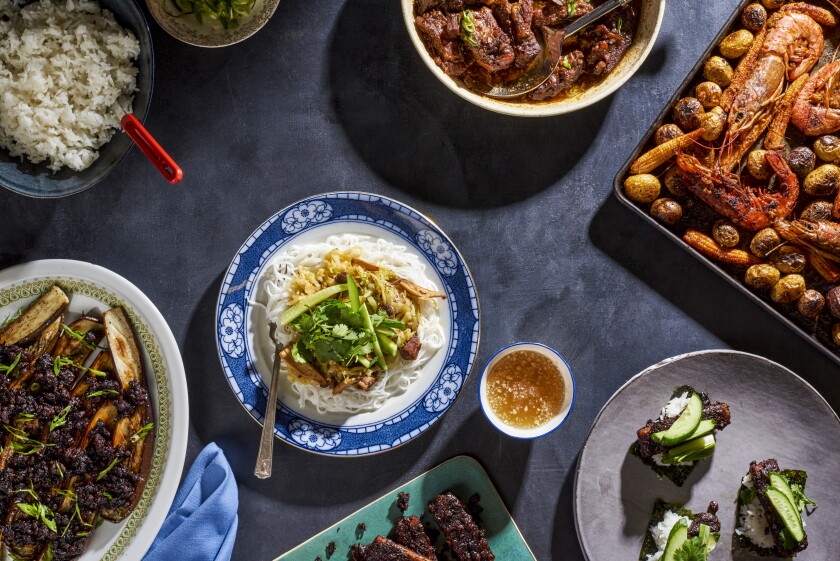 A spread of multiple dishes on a table, from Vietnamese pork spare ribs to a sheet pan shrimp boil.