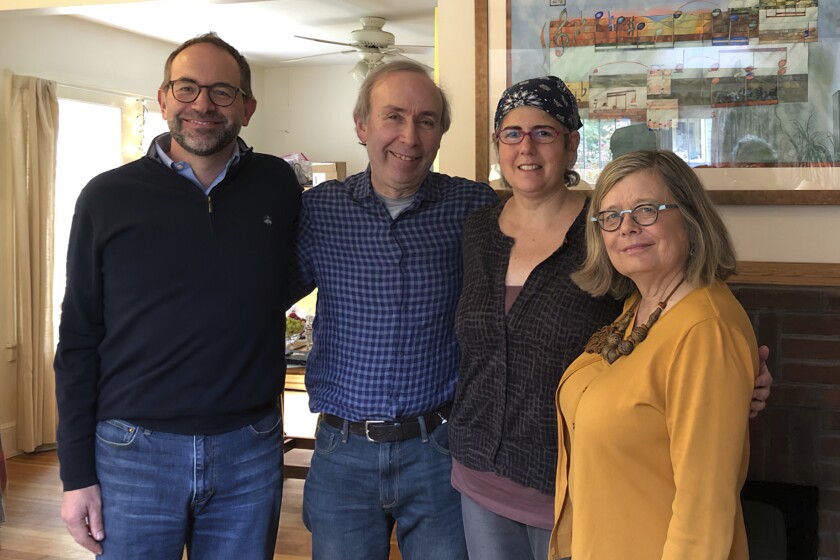 Associated Press Religion Writer Rachel Zoll, second from right, receives a visit in Amherst, Mass., on Oct. 26, 2018, from Managing Editor Brian J. Carovillano, editor at large Jerry Schwartz, and Deputy Managing Editor Sarah L. Nordgren after being awarded an Oliver S. Gramling Journalism Award for being AP's pre-eminent voice on religion for more than a decade. Zoll, who for 17 years as a religion writer for The Associated Press endeared herself to colleagues, competitors, and sources with her warm heart and world-class reporting skills, has died after a three-year bout with brain cancer. She was 55. (Cheryl Zoll via AP)