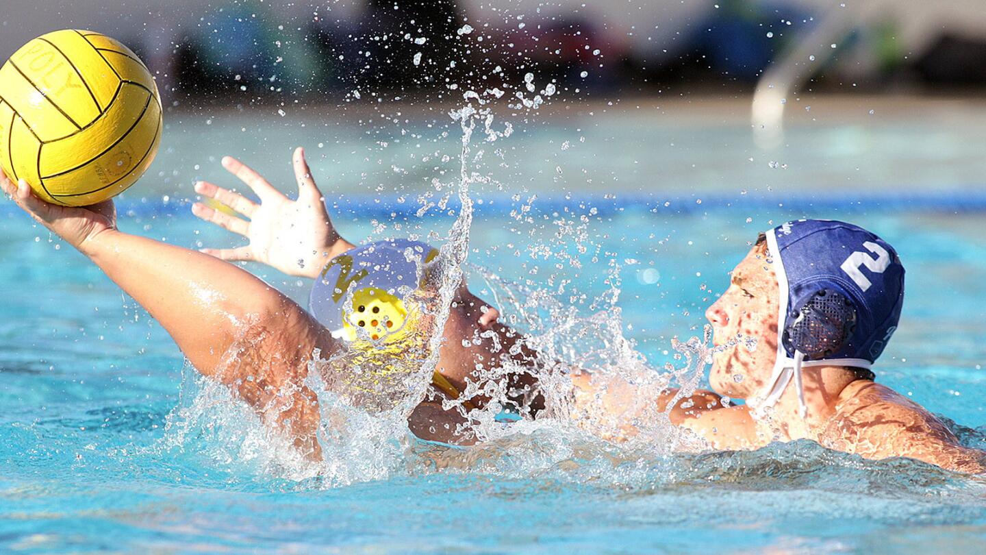 St. Francis' Carter Provencio leans back to keep the ball away from Flintridge Prep's Scott Fordham in a Pasadena Poly Summer League boys' water polo match at Pasadena Polytechnic on Wednesday, July 20, 2016.