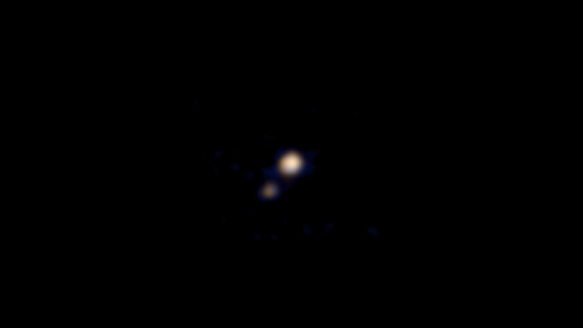 New Horizons' first color images of Pluto and its moon Charon.