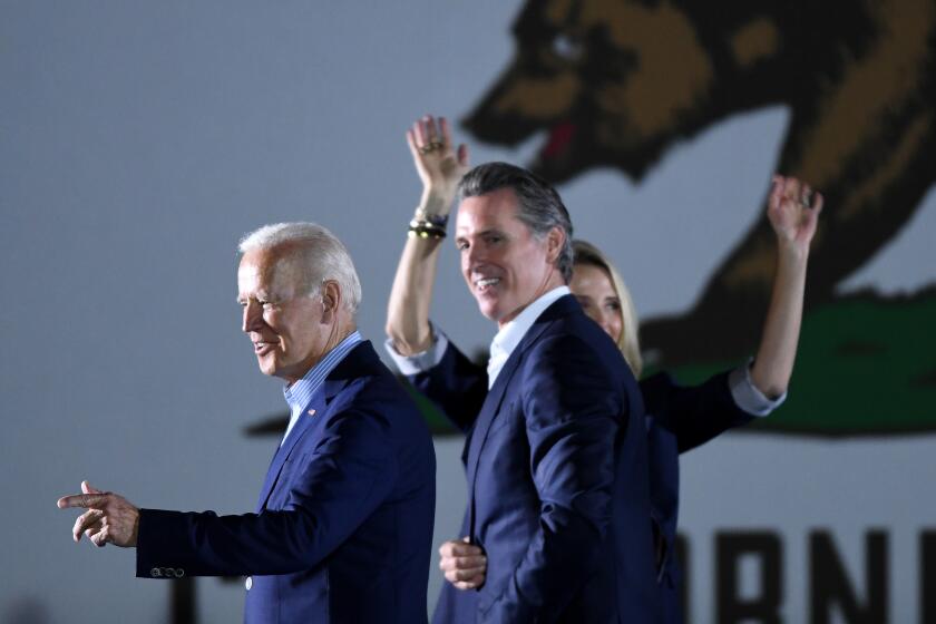 Long Beach, CA - September 13: U.S. US President Joe Biden (L) walks onstage with California Governor Gavin Newsom and his wife Jennifer Siebel Newsom during a campaign event at Long Beach City Collage, on Monday, Sept. 13, 2021 in Long Beach, CA. (Wally Skalij / Los Angeles Times)