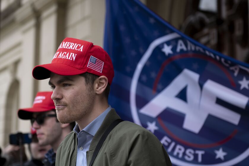 FILE - Nick Fuentes, far-right activist, holds a rally at the Lansing Capitol, in Lansing, Mich., Nov. 11, 2020. Former President Donald Trump had dinner Tuesday, Nov. 22, 2022, at his Mar-a-Lago club with the rapper formerly known as Kanye West, who is now known as Ye, as well as Nick Fuentes, who has used his online platform to spew antisemitic and white supremacist rhetoric. (Nicole Hester/Ann Arbor News via AP, File)