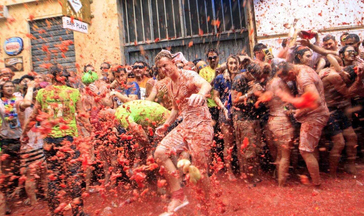 Revelers enjoy as they throw tomatoes at each other, during the annual "Tomatina", tomato fight fiesta, in the village of Bunol, 50 kilometers outside Valencia, Spain, Wednesday, Aug. 30, 2017.