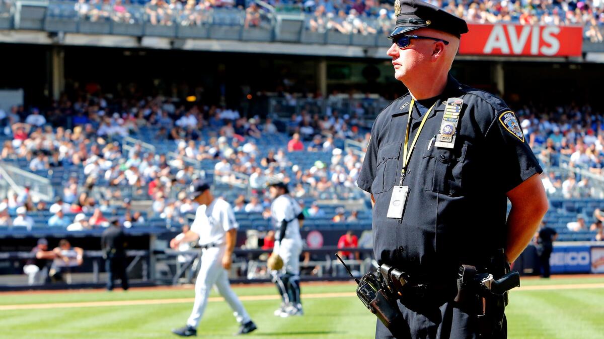 A police officer stands watch as a pitching change is made during a recent Yankees game.