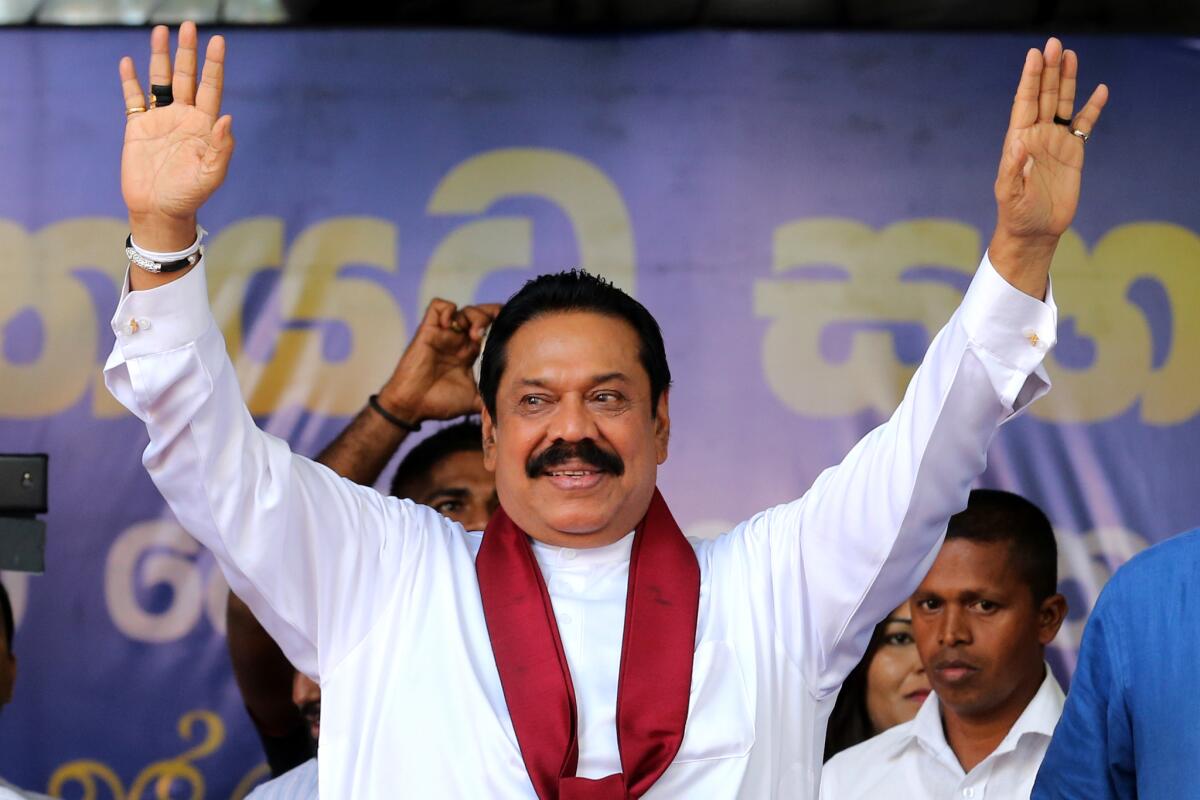 Sri Lankan parliamentary candidate Mahinda Rajapaksa, the country's former leader, waves to supporters at a campaign rally in Kandy on Aug. 14.