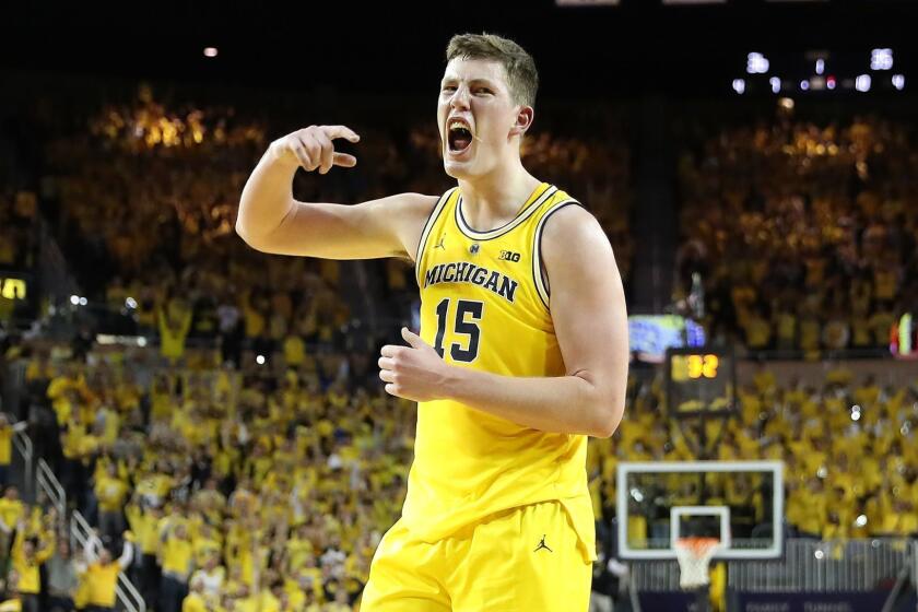 ANN ARBOR, MI - NOVEMBER 28: Jon Teske #15 of the Michigan Wolverines reacts to a three point shot made in the first half of the game against the North Carolina Tar Heels at Crisler Center on November 28, 2018 in Ann Arbor, Michigan. (Photo by Leon Halip/Getty Images) ** OUTS - ELSENT, FPG, CM - OUTS * NM, PH, VA if sourced by CT, LA or MoD **